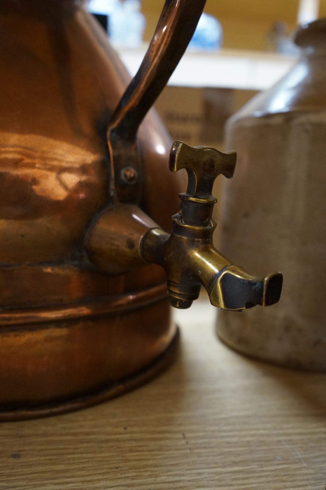 Three graduated copper haystack measures, H 39cm x W 40cm (inc spout), H 35cm x 25cm and H25cm x 18cm, Three stoneware jars H 32cm x W 20cm (two jars), H 20cm x W 16cm (1 jar)